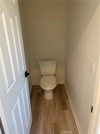 a bed sitting in a spacious bedroom next to a window