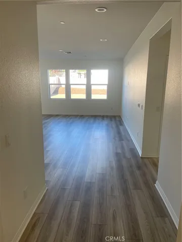 a view of a living room kitchen and a refrigerator