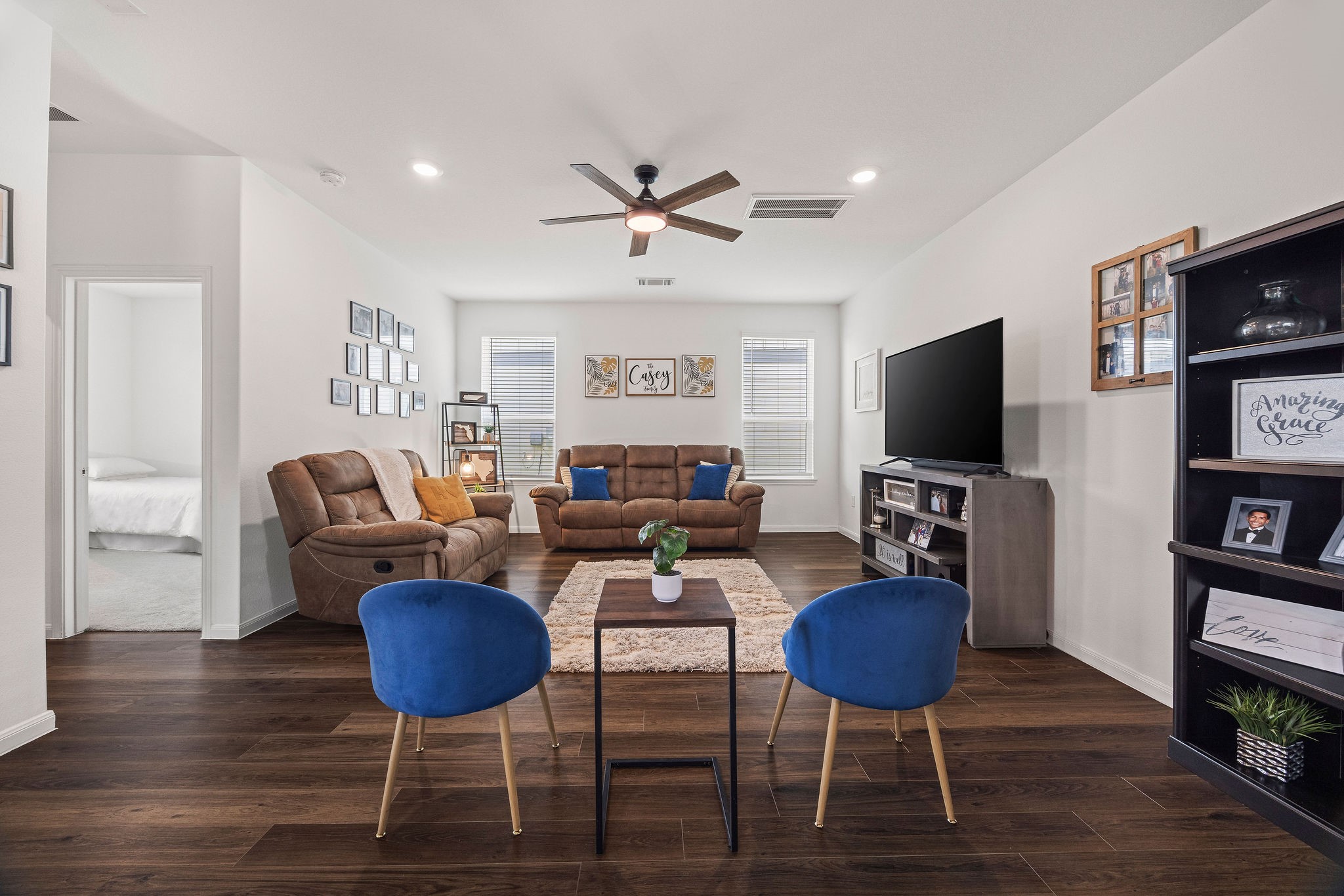 23334 Simmental Road Hockley, TX 77447 - Photo 4 of 38 This inviting family room offers an ideal space for relaxation and entertaining, featuring an open-concept layout that seamlessly transitions into the kitchen and dining area.