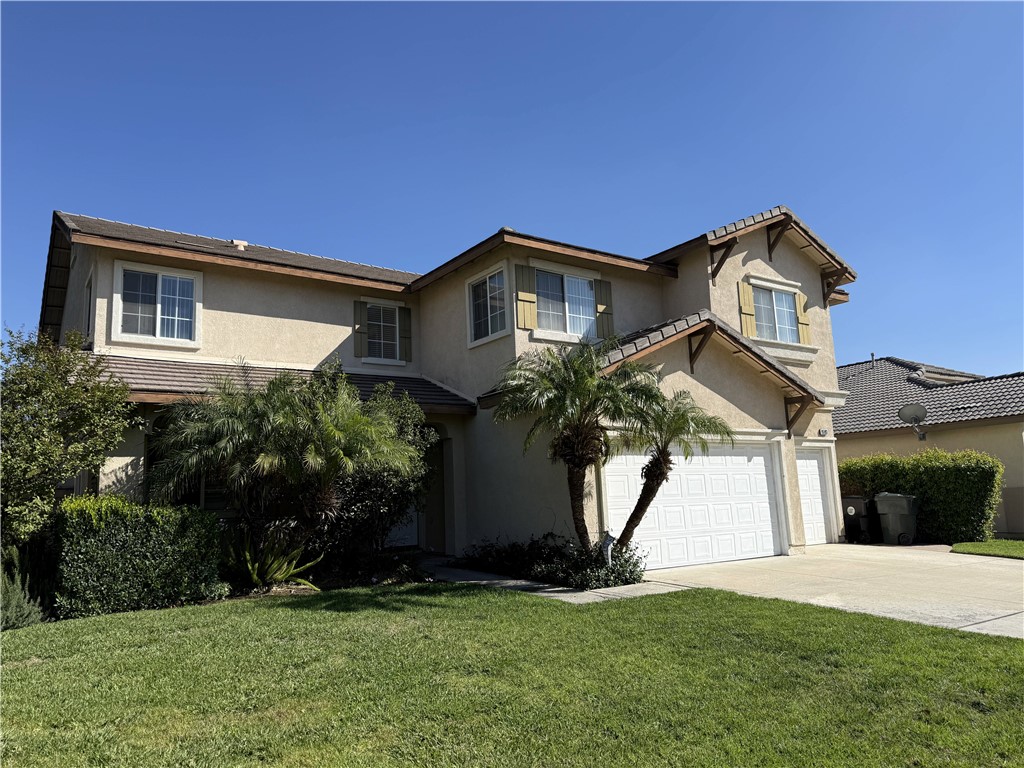 9593 Heartland Place Rancho Cucamonga, CA 91730 - Photo 13 of 13 a front view of a house with a yard and garage