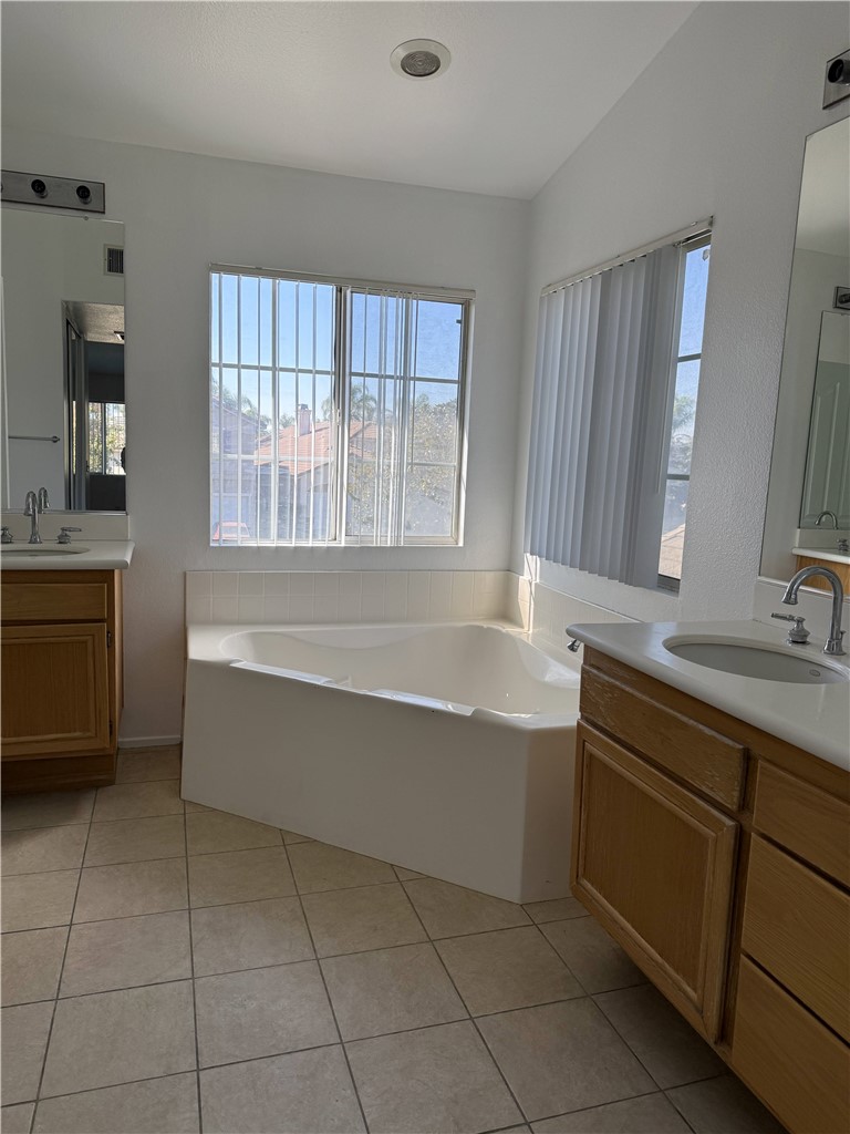 9593 Heartland Place Rancho Cucamonga, CA 91730 - Photo 6 of 13 a bathroom with a tub sink and mirror