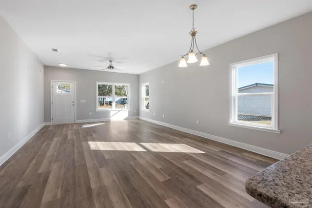 a view of livingroom with hardwood floor and a ceiling fan
