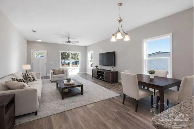 a living room with furniture a fireplace and a flat screen tv