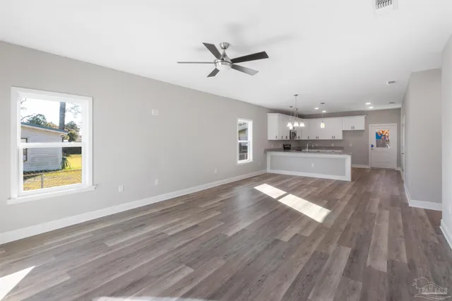 a view of outdoor space with wooden floor and windows