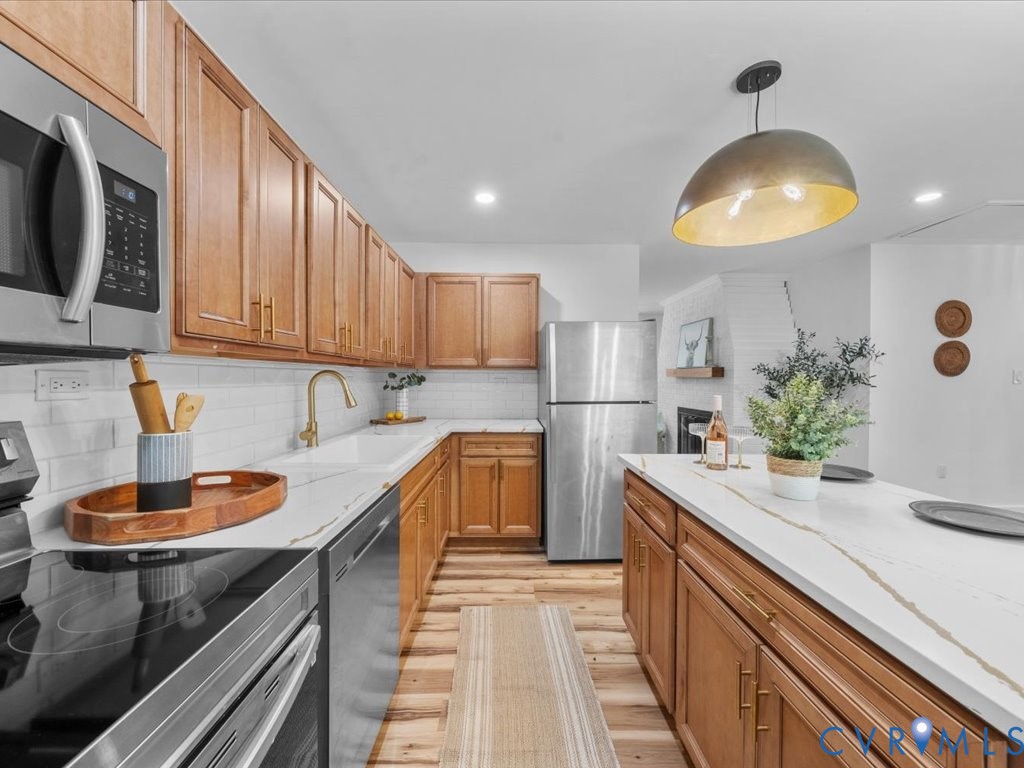2291 Pony Farm Road Maidens, VA 23102 - Photo 11 of 43 a kitchen with stainless steel appliances granite countertop a sink a stove and a wooden floors