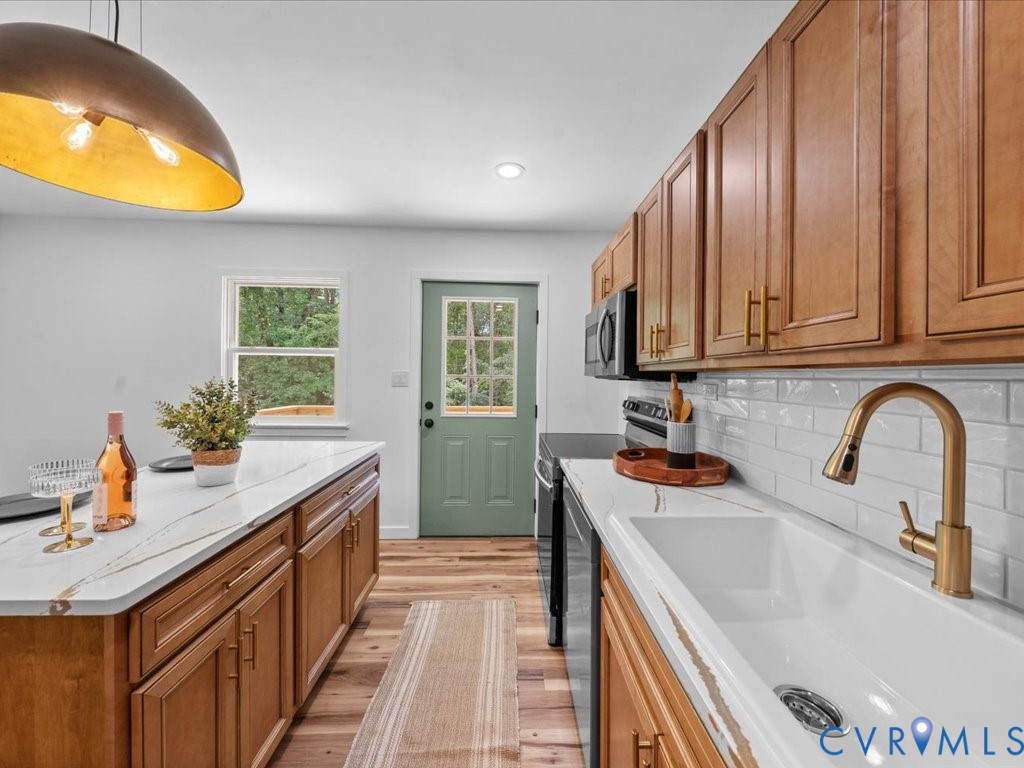 2291 Pony Farm Road Maidens, VA 23102 - Photo 13 of 43 a kitchen with stainless steel appliances granite countertop a sink stove and cabinets