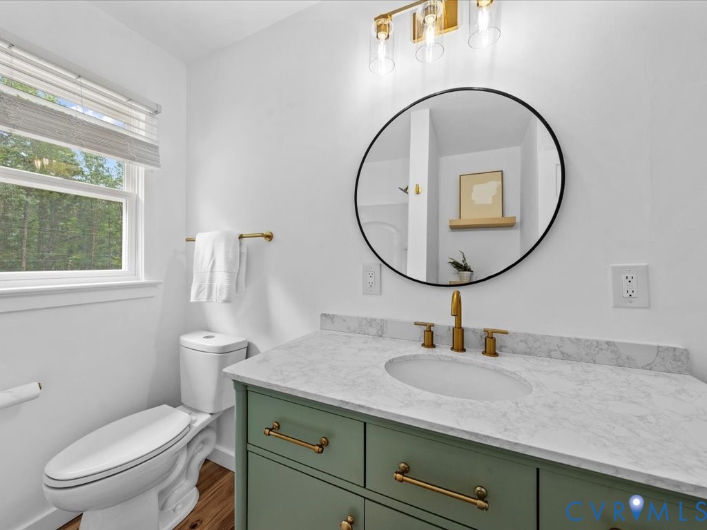 2291 Pony Farm Road Maidens, VA 23102 - Photo 23 of 43 a bathroom with a granite countertop toilet a sink and a mirror