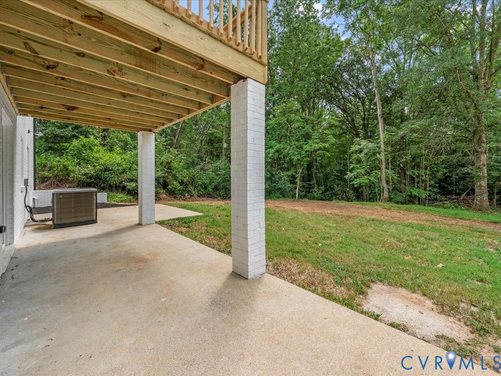 2291 Pony Farm Road Maidens, VA 23102 - Photo 42 of 43 a view of a patio with a table and chairs under an umbrella