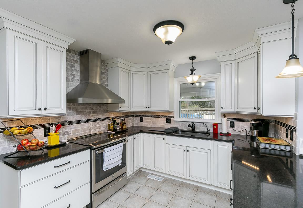 2289 Callis Road Lebanon, TN 37090 - Photo 3 of 20 a kitchen with a sink white cabinets and black appliances