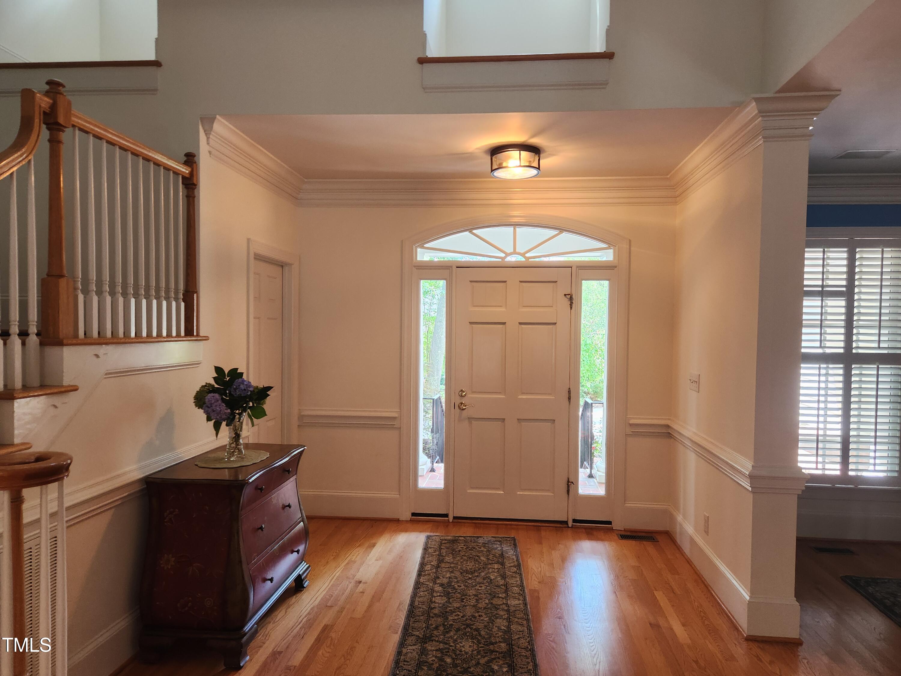 7516 Wingfoot Drive Raleigh, NC 27615 - Photo 14 of 34 a view of a hallway with wooden floor and staircase
