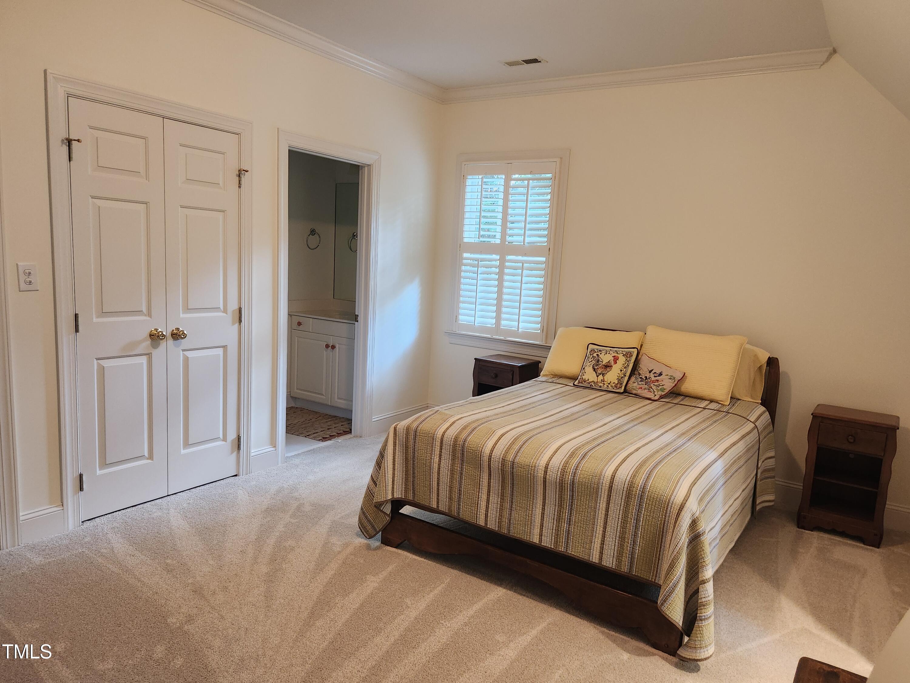 7516 Wingfoot Drive Raleigh, NC 27615 - Photo 21 of 34 a bedroom with a bed and closet
