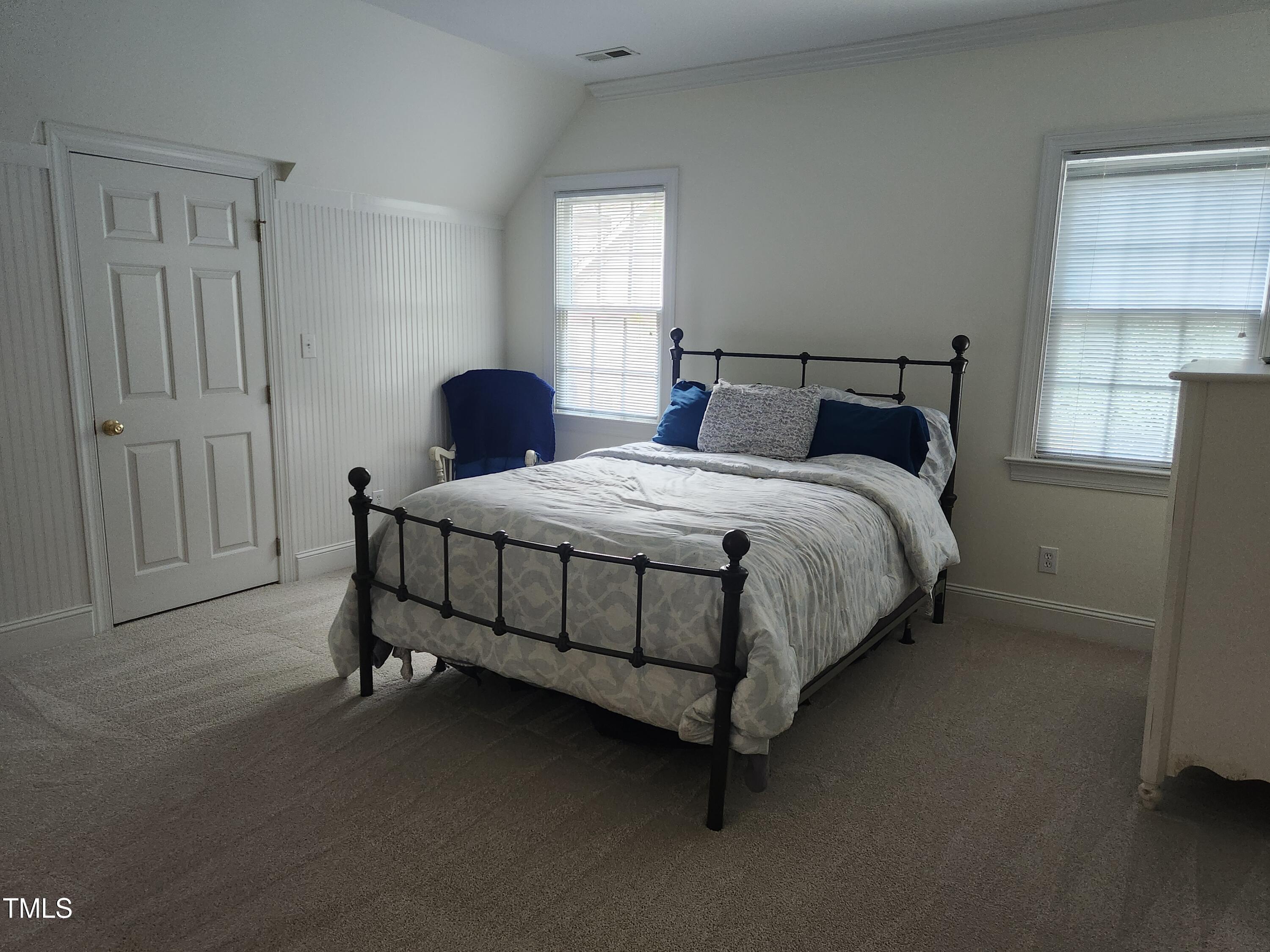 7516 Wingfoot Drive Raleigh, NC 27615 - Photo 25 of 34 a bedroom with a bed and window