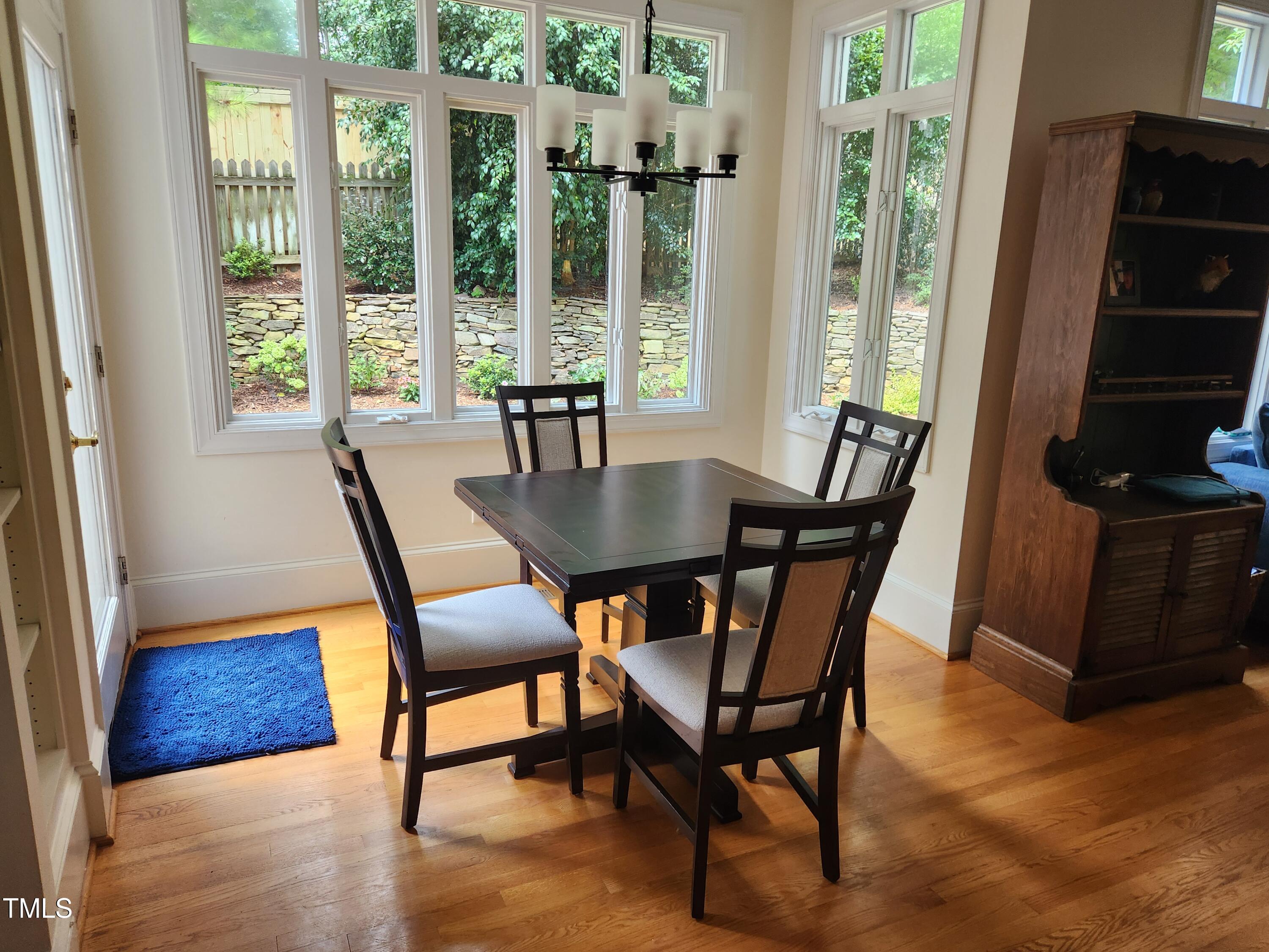 7516 Wingfoot Drive Raleigh, NC 27615 - Photo 26 of 34 a view of a dining room with furniture window and wooden floor