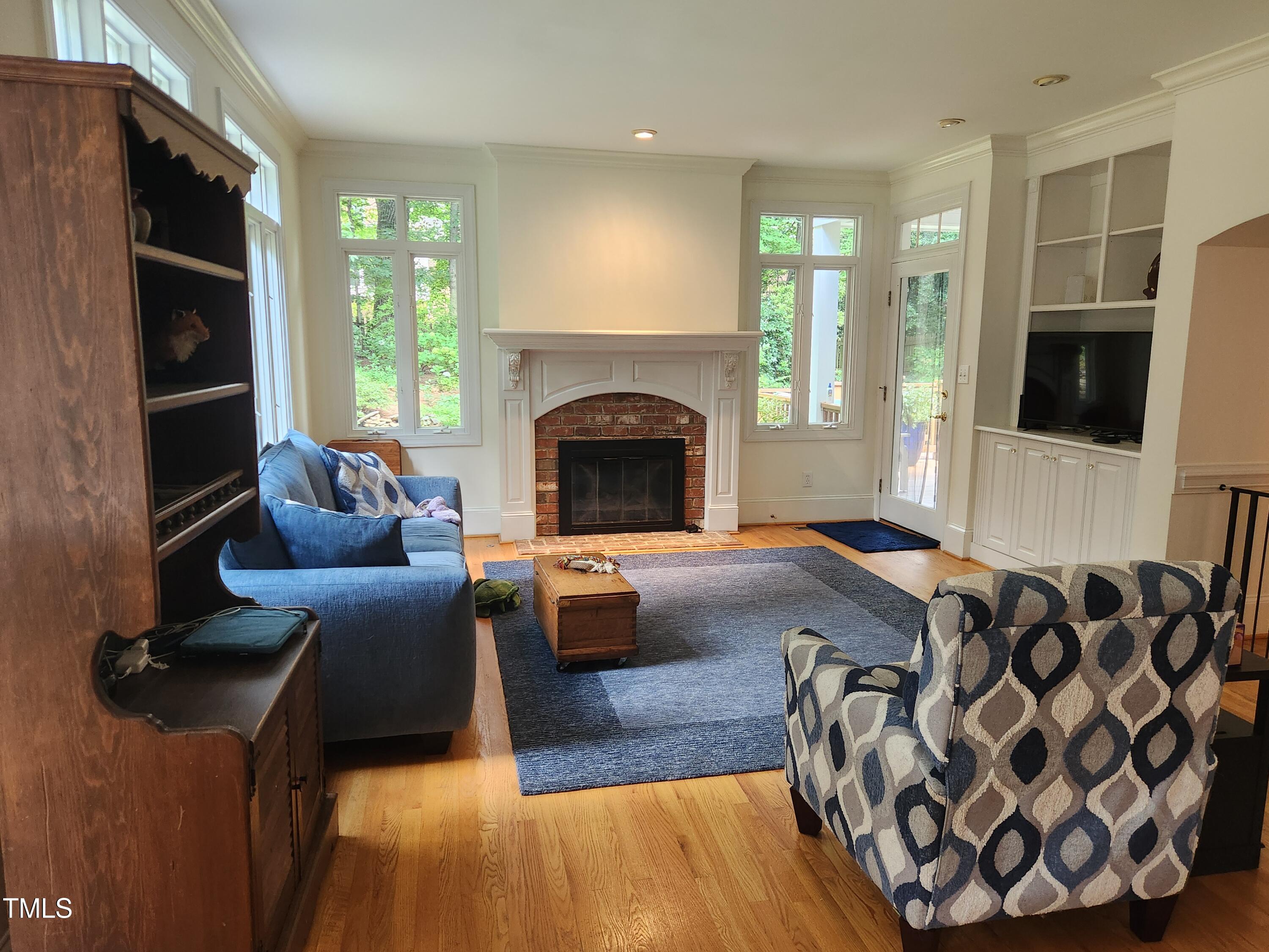 7516 Wingfoot Drive Raleigh, NC 27615 - Photo 27 of 34 a living room with furniture and a fireplace