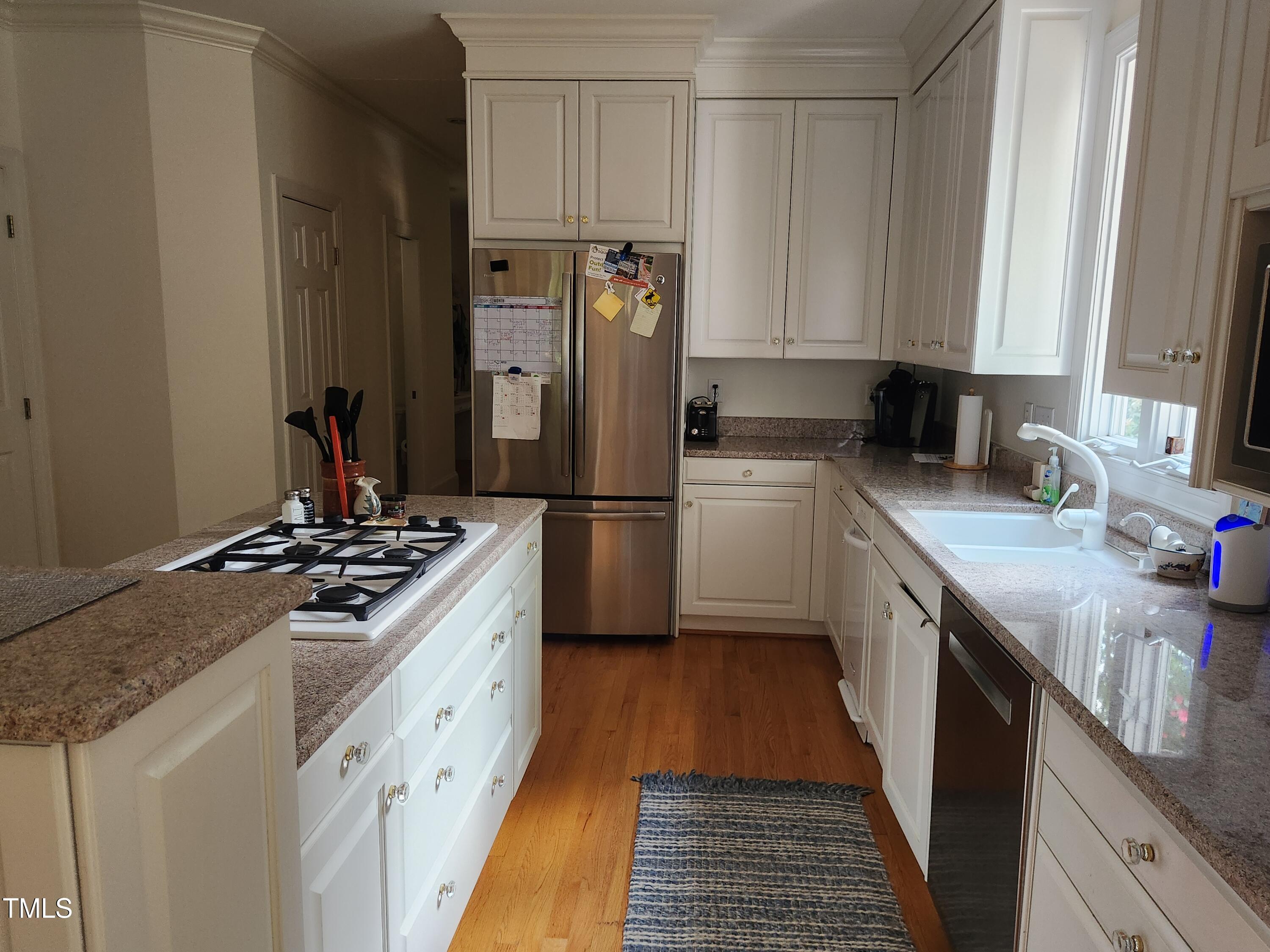 7516 Wingfoot Drive Raleigh, NC 27615 - Photo 28 of 34 a kitchen with a stove sink and refrigerator