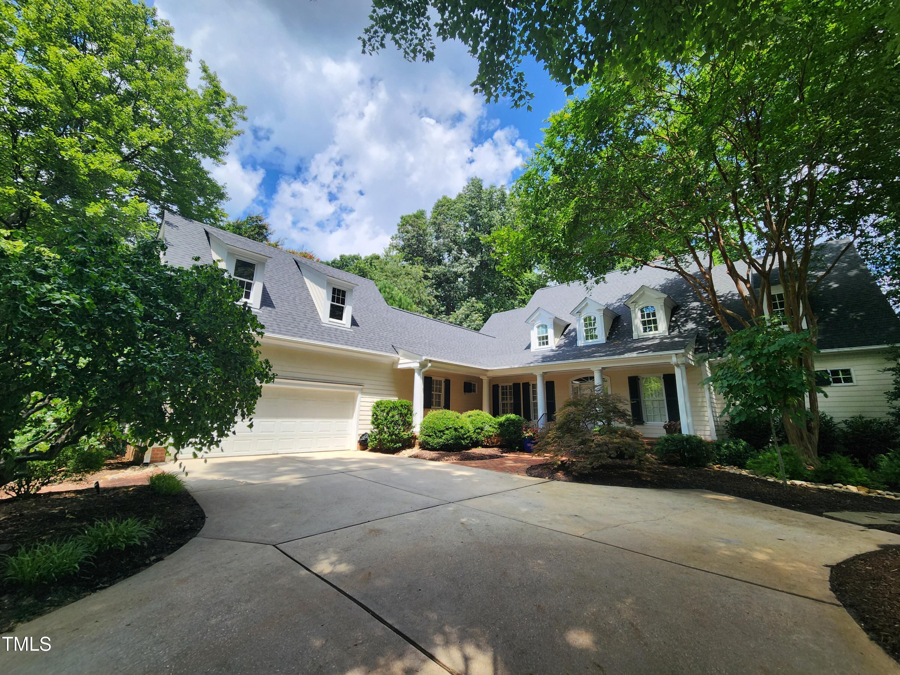7516 Wingfoot Drive Raleigh, NC 27615 - Photo 4 of 34 a front view of a house with a yard and a garage