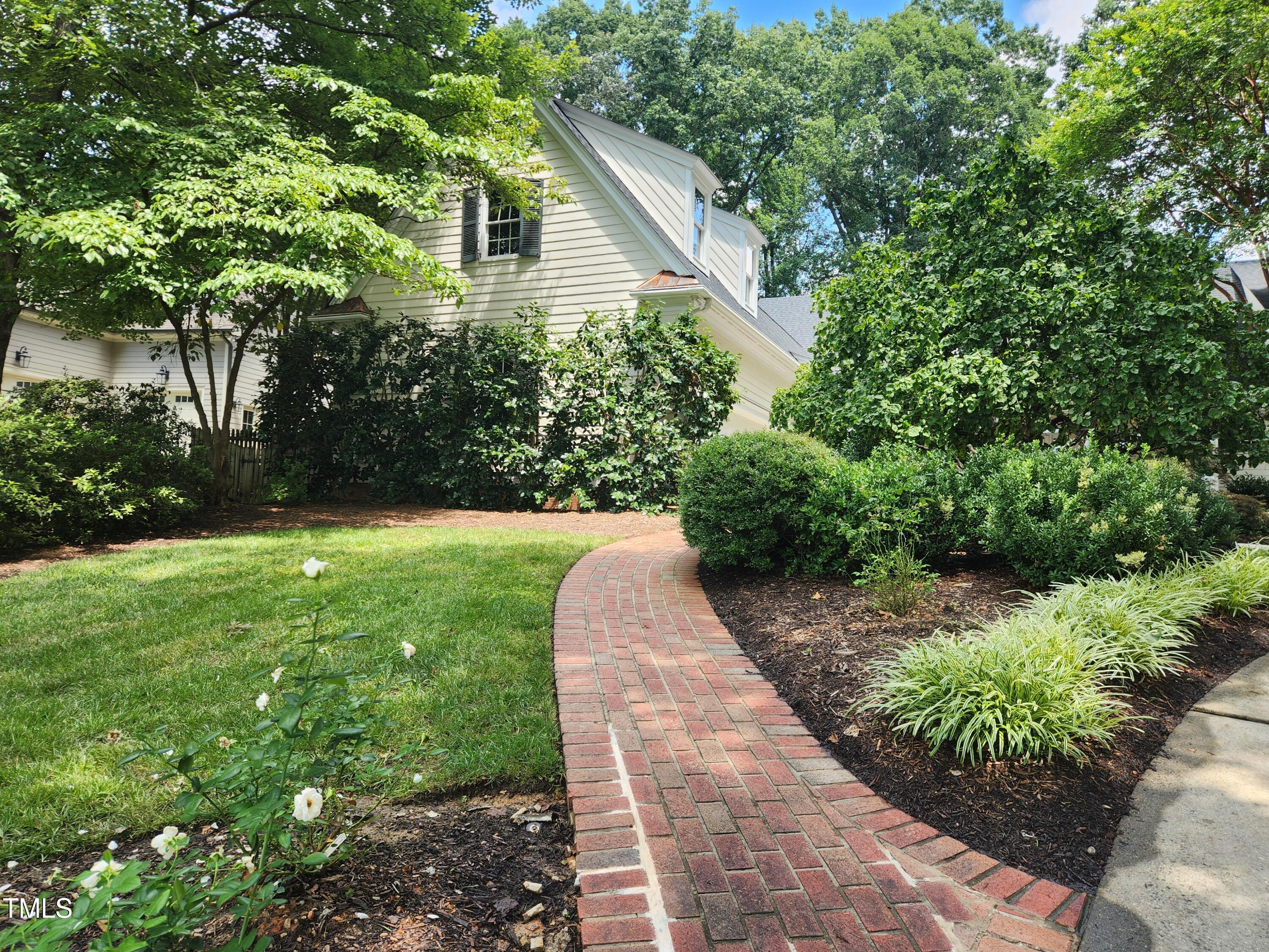 7516 Wingfoot Drive Raleigh, NC 27615 - Photo 5 of 34 a view of a back yard with plants and large trees