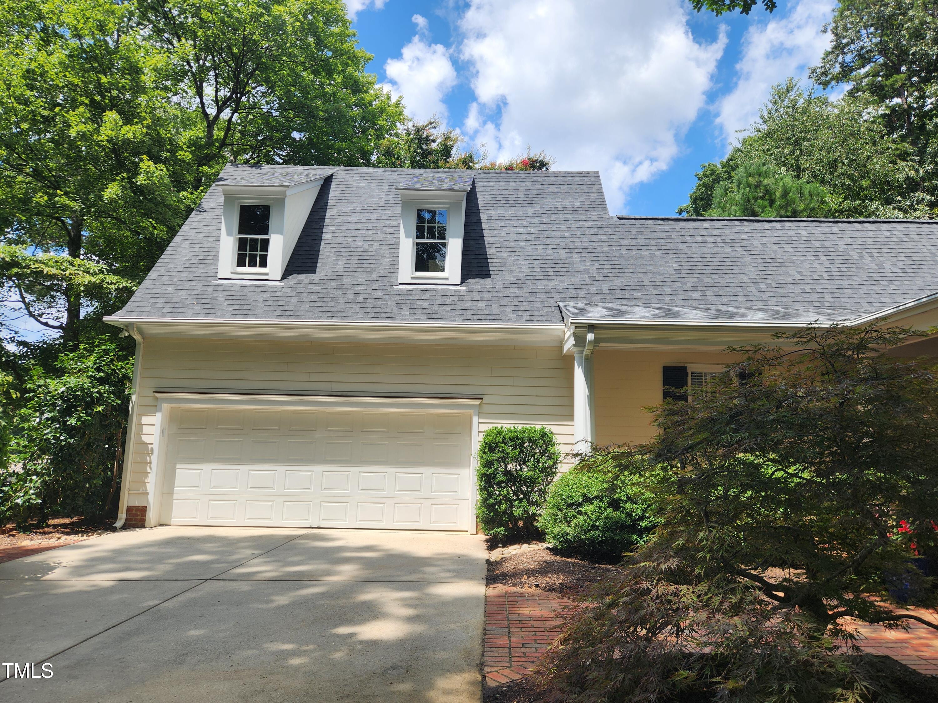 7516 Wingfoot Drive Raleigh, NC 27615 - Photo 6 of 34 a front view of a house with a yard and garage