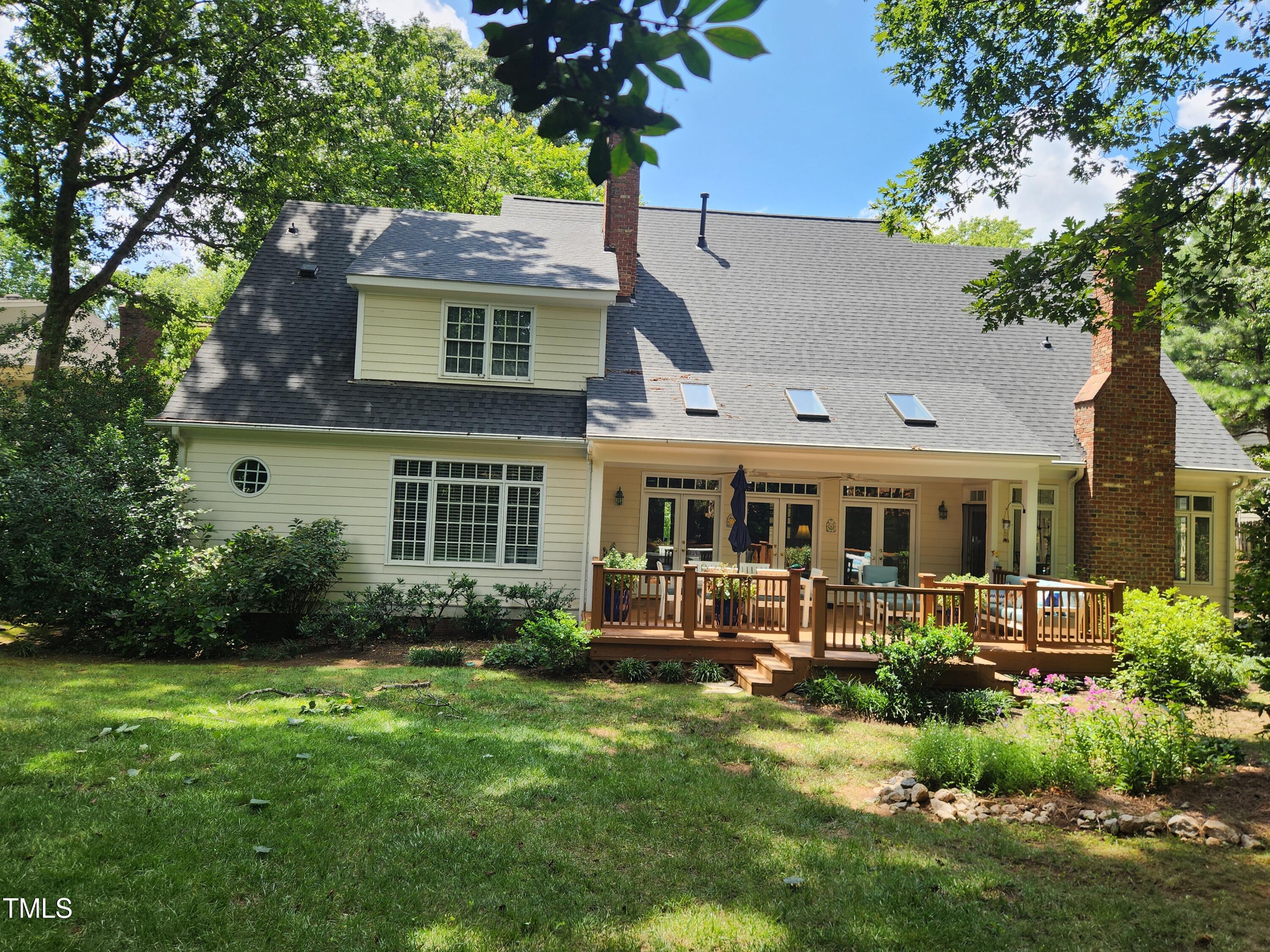 7516 Wingfoot Drive Raleigh, NC 27615 - Photo 7 of 34 a front view of a house with garden and trees