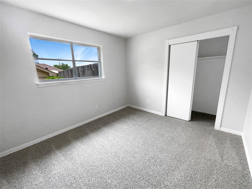 3925 Wedgworth Road South Fort Worth, TX 76133 - Photo 11 of 15 a view of an empty room with closet and wooden floor