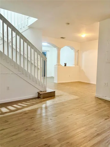 a view of a room with wooden floor