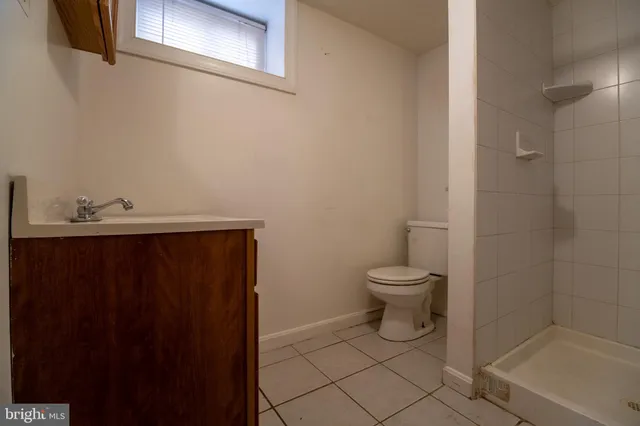 a bathroom with a toilet a sink and shower
