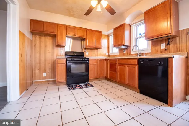 a kitchen with stainless steel appliances granite countertop a stove a sink dishwasher and a refrigerator