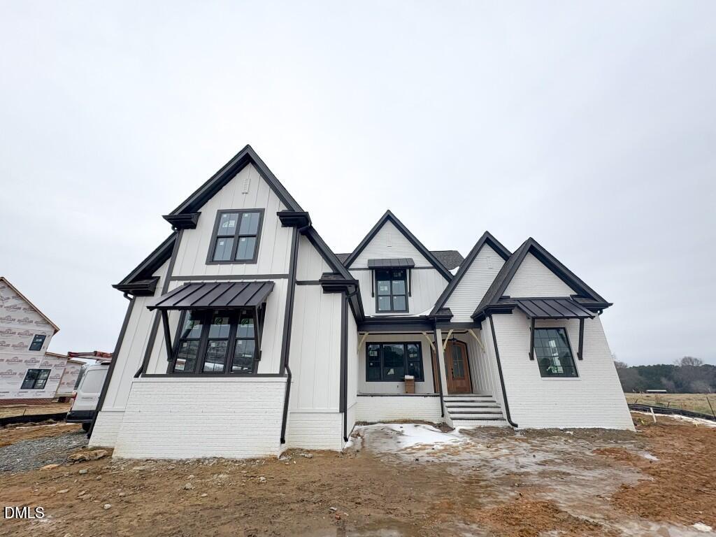 5816 Carriage Drive Raleigh, NC 27603 - Photo 1 of 14 a view of a big house with wooden fence