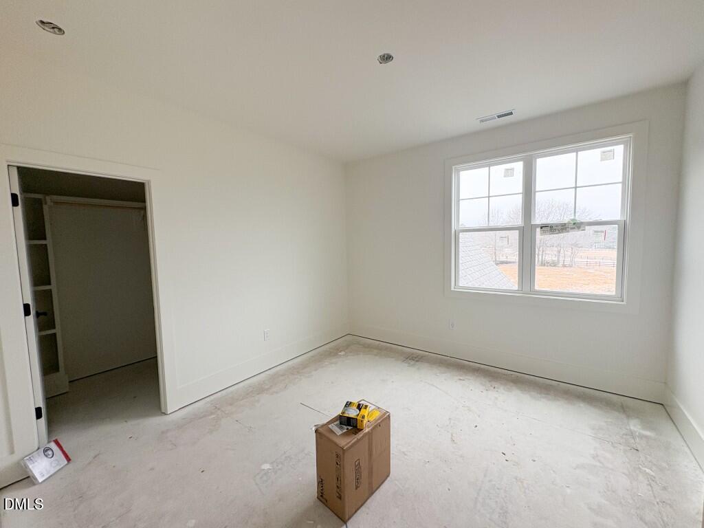5816 Carriage Drive Raleigh, NC 27603 - Photo 11 of 14 an empty room with windows