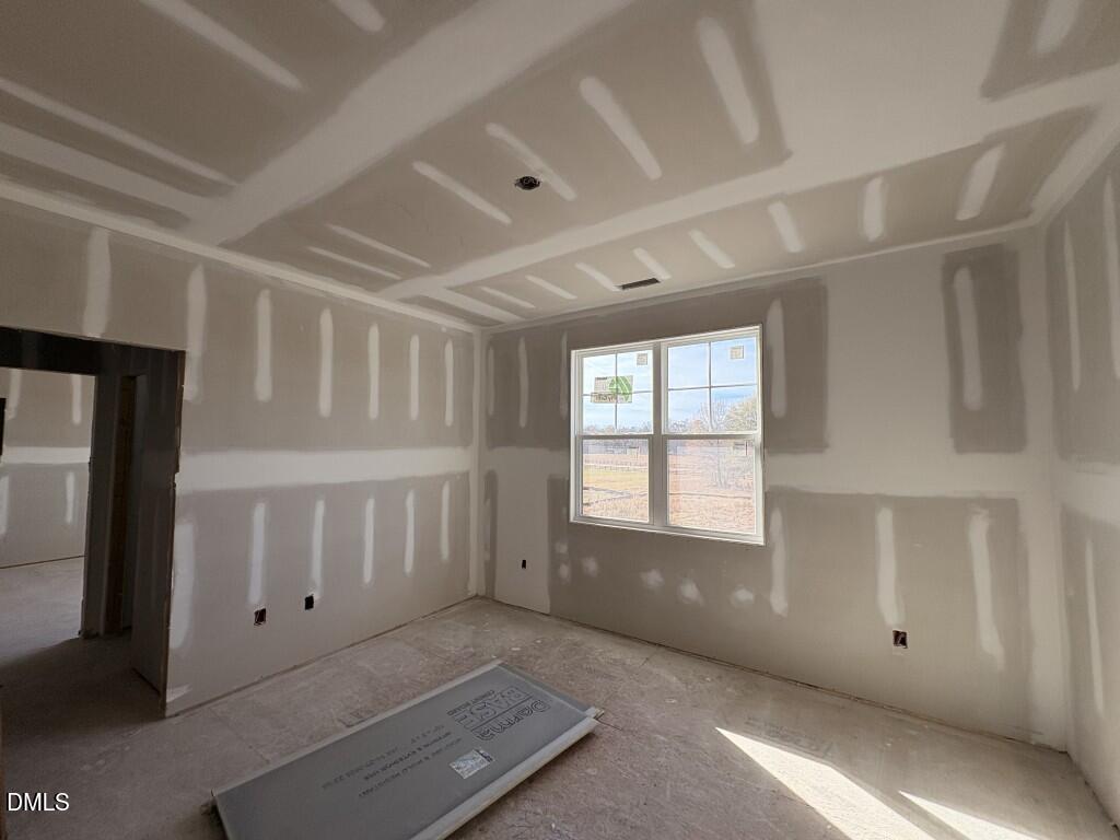 5816 Carriage Drive Raleigh, NC 27603 - Photo 7 of 13 a view of an empty room with a window