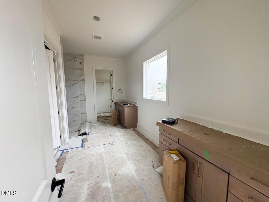 5816 Carriage Drive Raleigh, NC 27603 - Photo 5 of 14 a storage room with a sink and cabinets