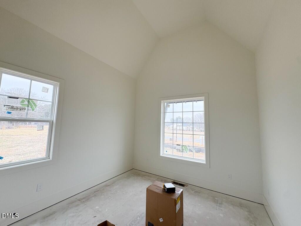 5816 Carriage Drive Raleigh, NC 27603 - Photo 7 of 14 an empty room with windows