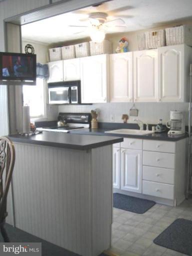 2248 Southorn Road Middle River, MD 21220 - Photo 15 of 21 a kitchen with stainless steel appliances a sink stove and cabinets