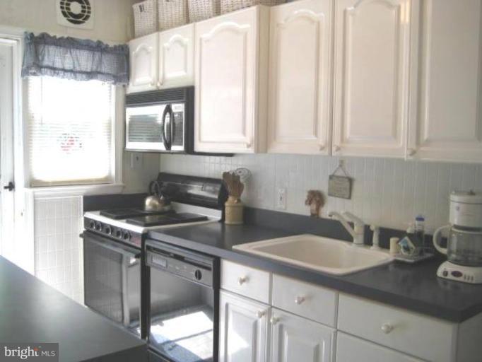 2248 Southorn Road Middle River, MD 21220 - Photo 16 of 21 a kitchen with stainless steel appliances granite countertop a sink a stove and a granite counter tops with white cabinets