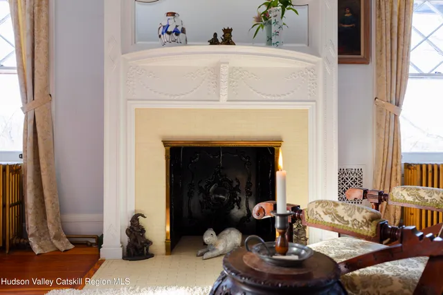 a view of a hallway and a livingroom with furniture and front door
