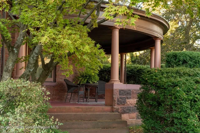 a view of a patio with table and chairs and potted plants