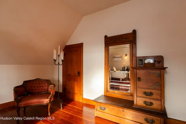 a bedroom with furniture and a window