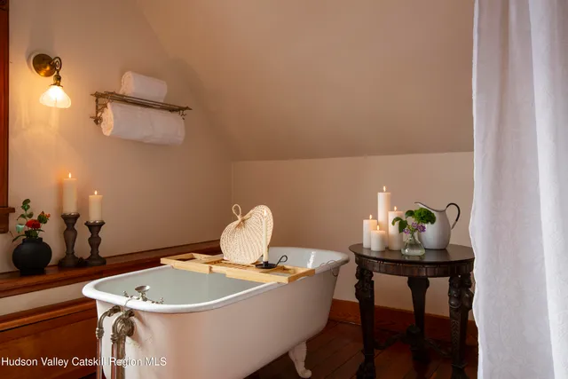 a bedroom with a bed next to a window