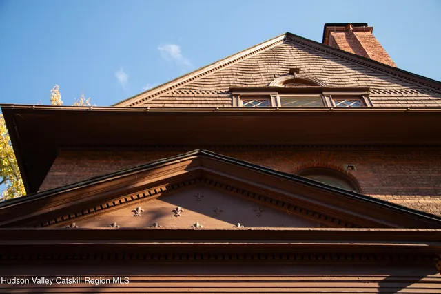 front view of a brick house with large windows