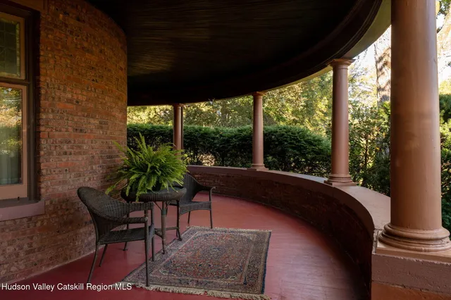 a dining room with furniture and a potted plant