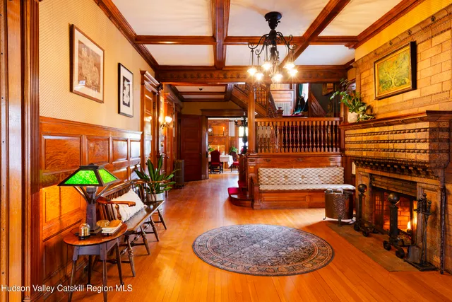 a view of a room with furniture and wooden floor