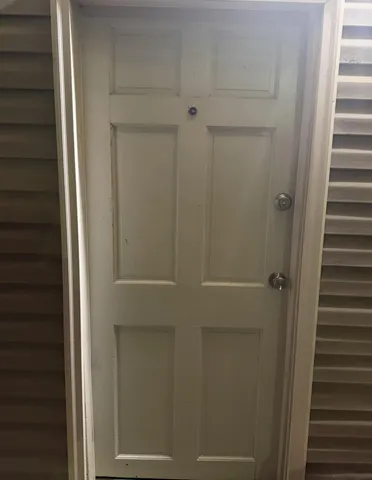 a view of a hallway with a door