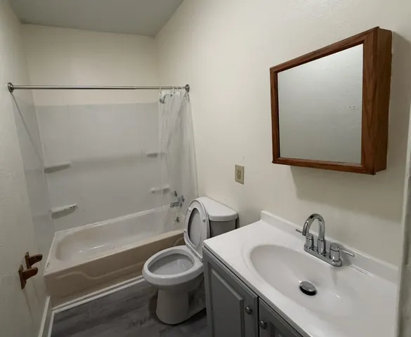 a bathroom with a toilet sink and bathtub