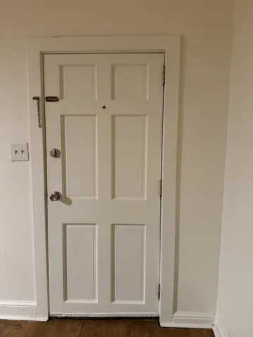 a kitchen with granite countertop a stove cabinets and wooden floor