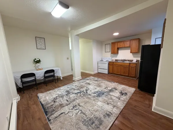 a kitchen with stainless steel appliances granite countertop a sink stove and refrigerator