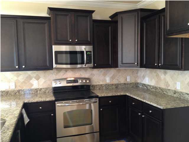 123 Grayling Way Inlet Beach, FL 32461 - Photo 3 of 6 a kitchen with granite countertop cabinets stove and microwave