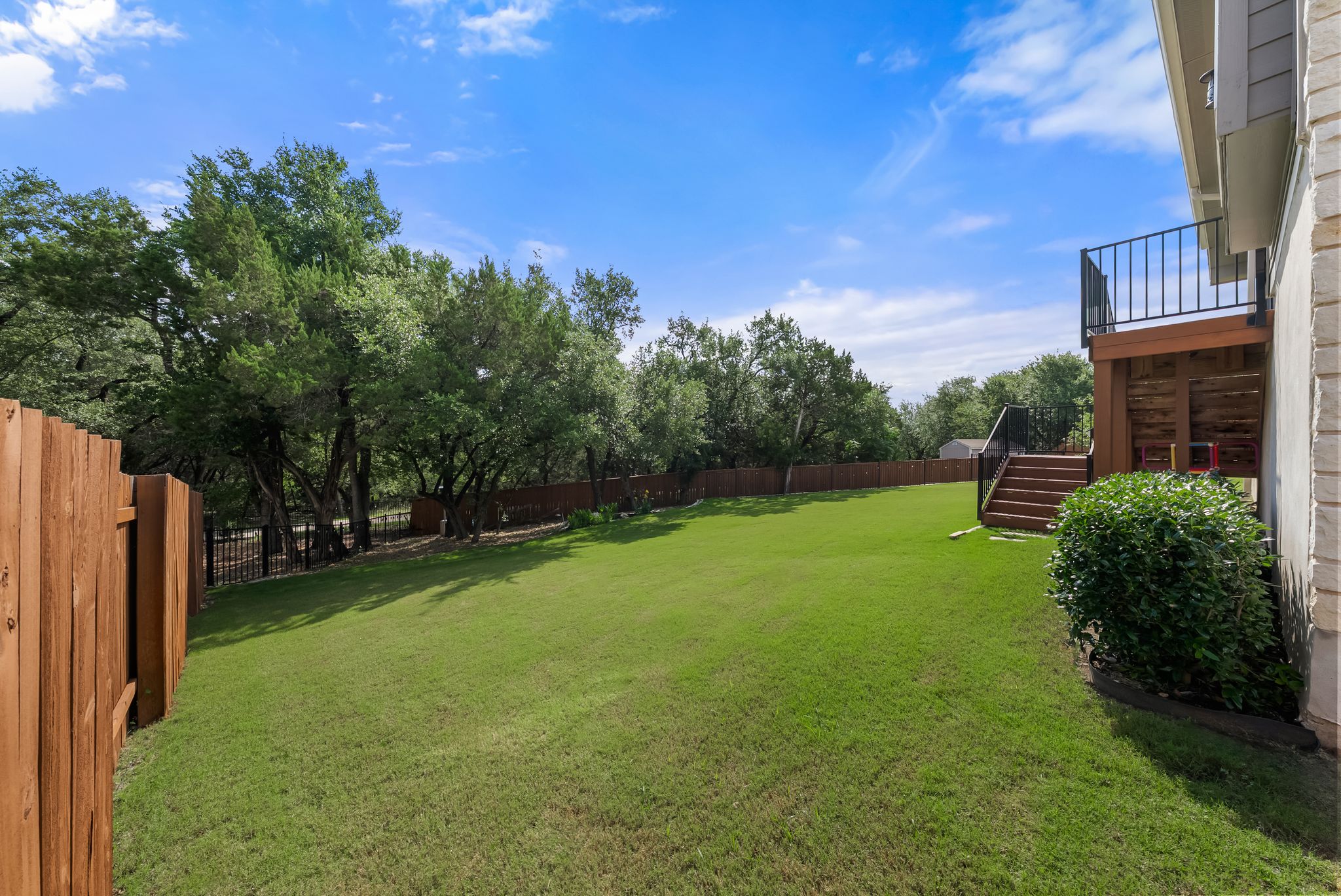 300 Prato Place Georgetown, TX 78628 - Photo 32 of 40 A spacious, verdant yard unfolds beneath a clear sky, offering a perfect outdoor retreat.
