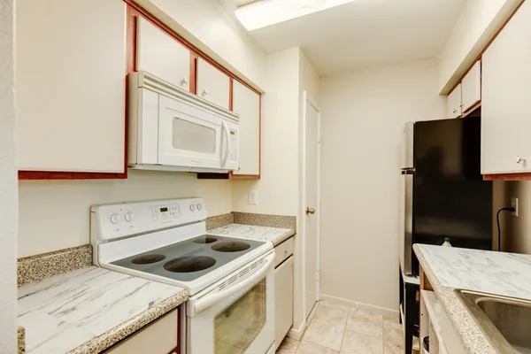 a kitchen with a stove and a microwave