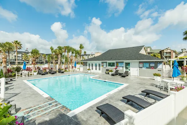 a view of a house with swimming pool and furniture