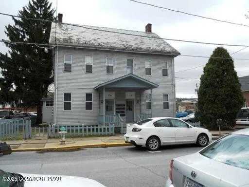 a view of a car parked in front of a house